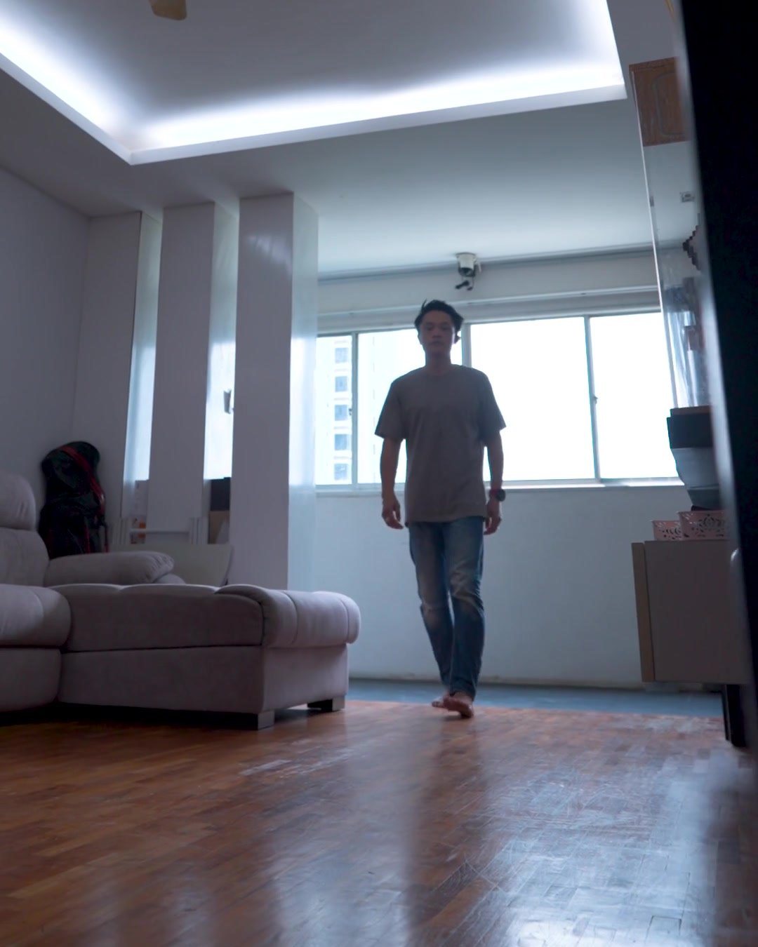 Alvin walking into an empty living room before a handover